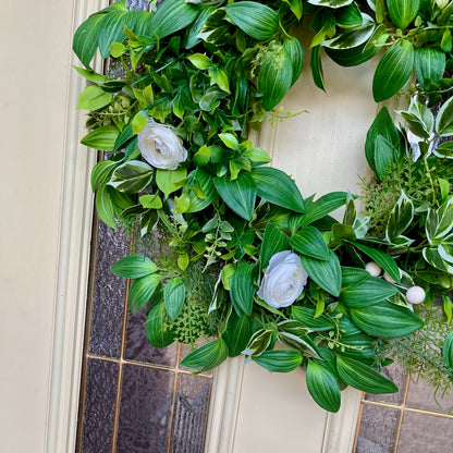 Handcrafted lush greenery front door wreath with white roses. Elegant farmhouse decor perfect for spring, summer, and year-round display.