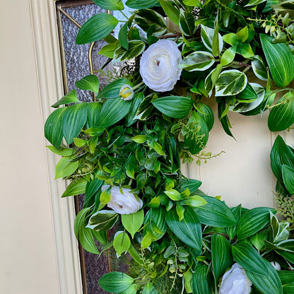 Handcrafted lush greenery front door wreath with white roses. Elegant farmhouse decor perfect for spring, summer, and year-round display.