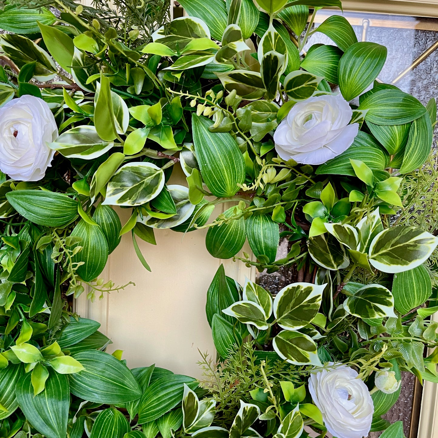 Handcrafted lush greenery front door wreath with white roses. Elegant farmhouse decor perfect for spring, summer, and year-round display.