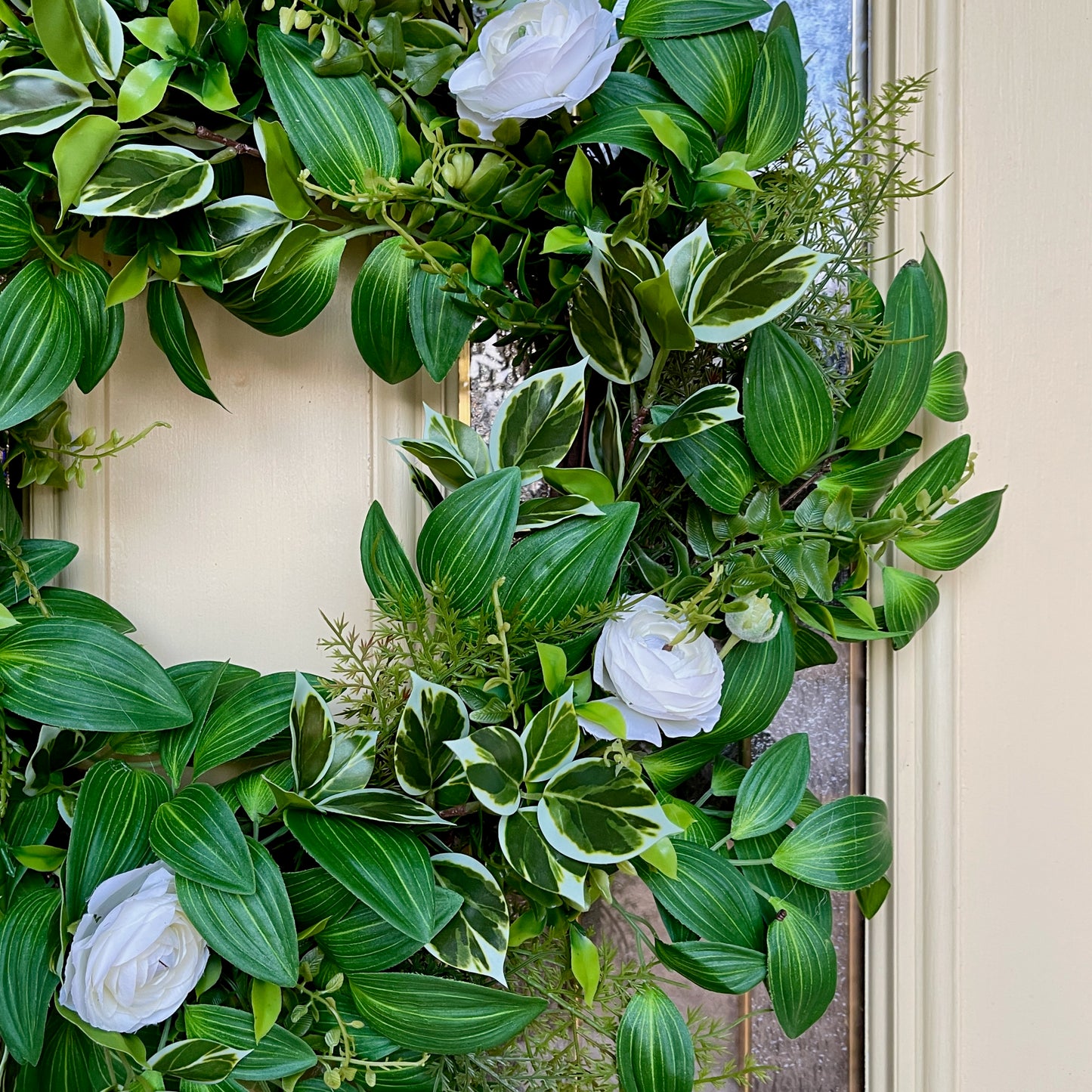 Handcrafted lush greenery front door wreath with white roses. Elegant farmhouse decor perfect for spring, summer, and year-round display.