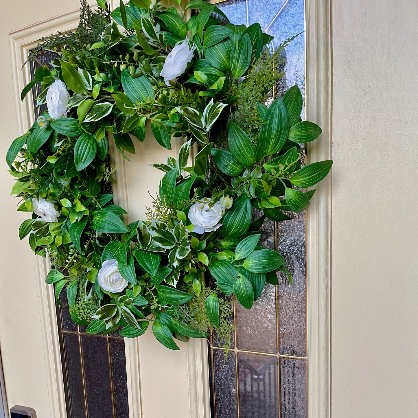 Handcrafted lush greenery front door wreath with white roses. Elegant farmhouse decor perfect for spring, summer, and year-round display.