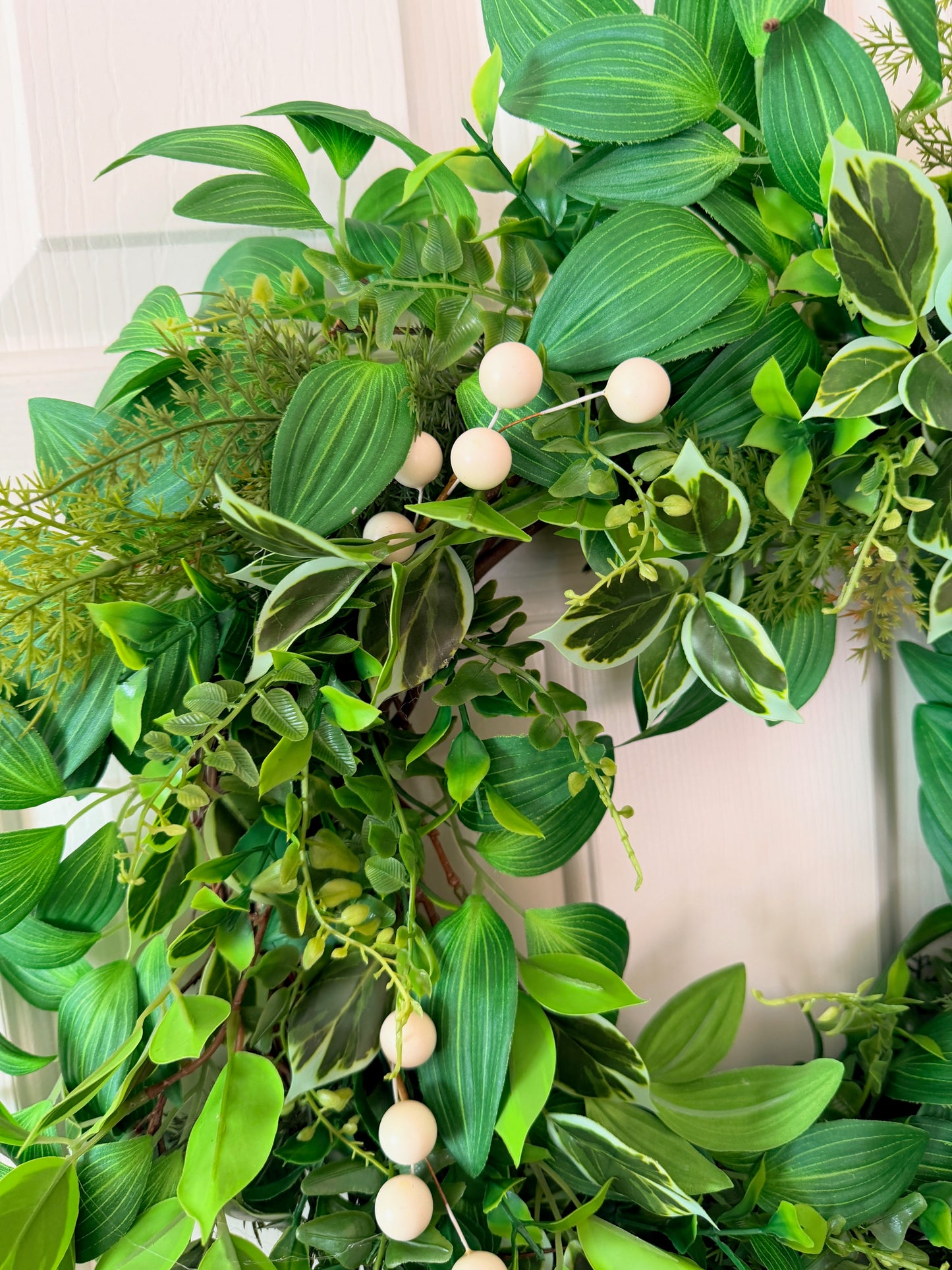 Handcrafted lush greenery front door wreath with white roses. Elegant farmhouse decor perfect for spring, summer, and year-round display.