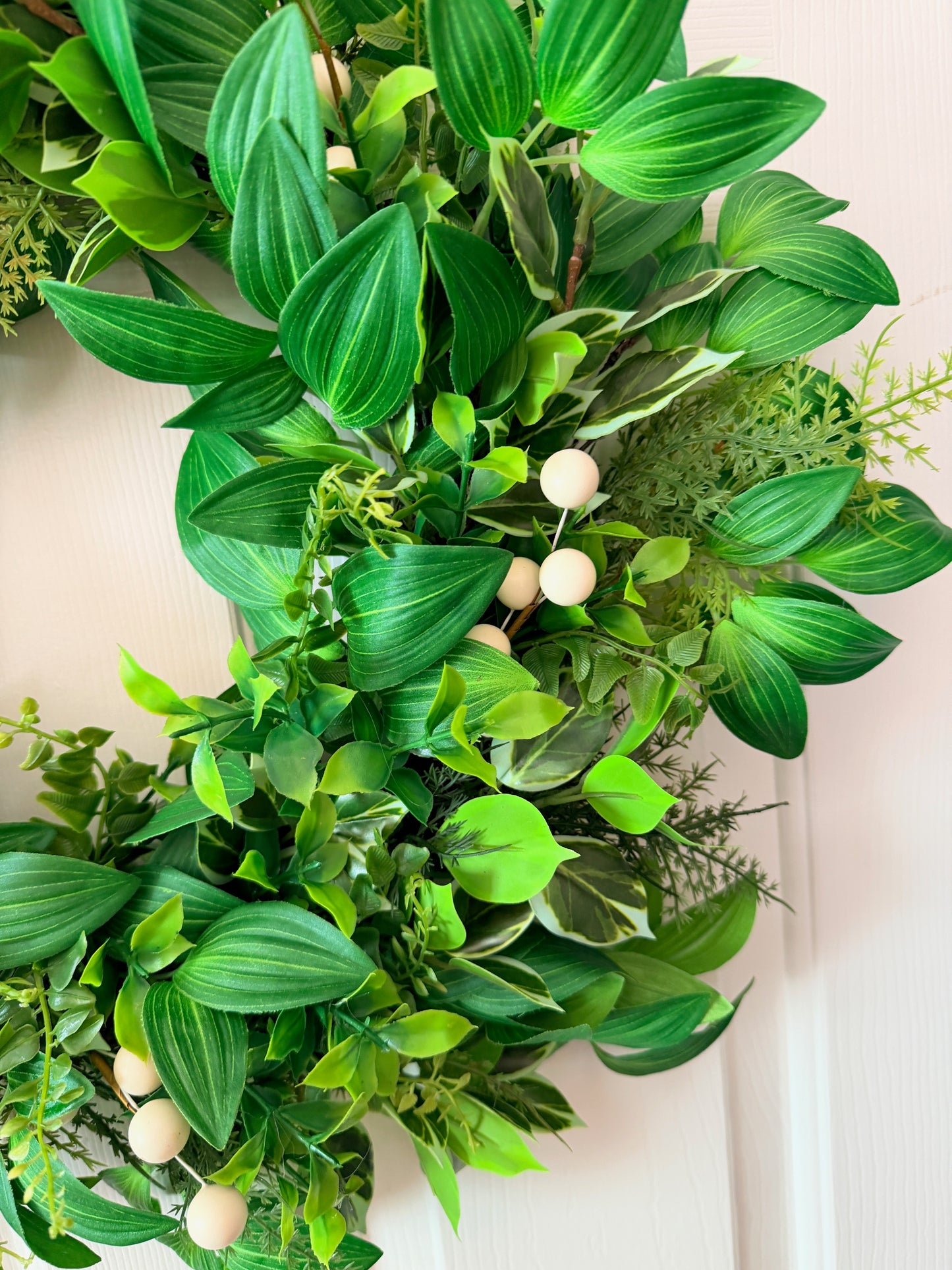 Handcrafted lush greenery front door wreath with white roses. Elegant farmhouse decor perfect for spring, summer, and year-round display.