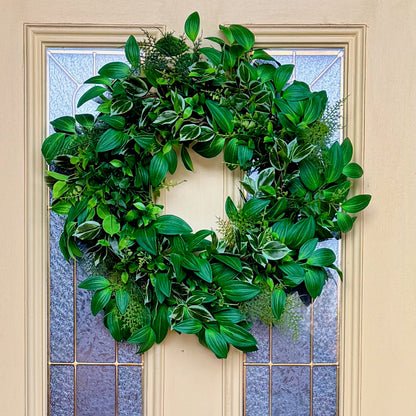 Handcrafted lush greenery front door wreath with white roses. Elegant farmhouse decor perfect for spring, summer, and year-round display.