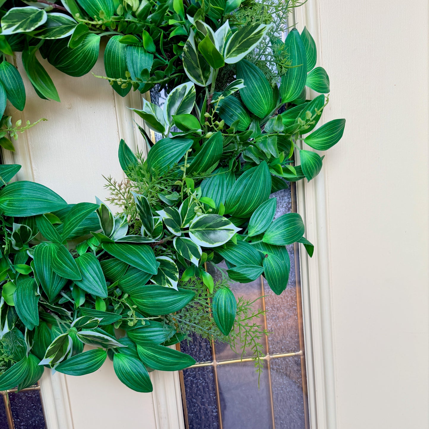 Handcrafted lush greenery front door wreath with white roses. Elegant farmhouse decor perfect for spring, summer, and year-round display.