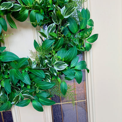 Handcrafted lush greenery front door wreath with white roses. Elegant farmhouse decor perfect for spring, summer, and year-round display.