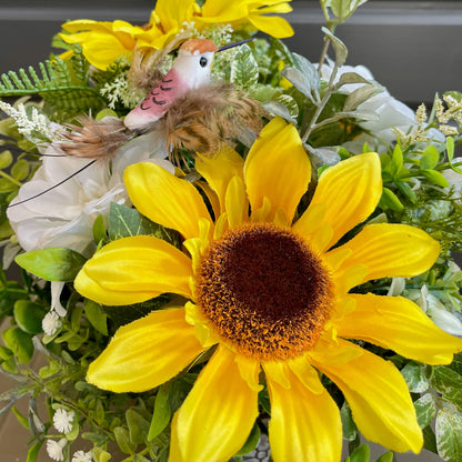 Yellow sunflower with a decorative bird on a floral background