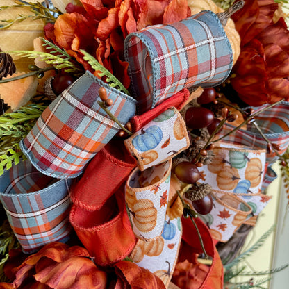 Decorative bow with autumn-themed ribbons and leaves