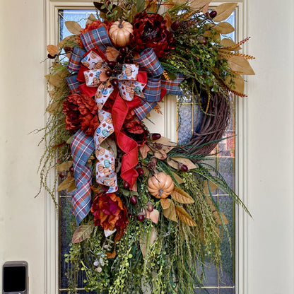 Decorative wreath with autumnal elements on a door
