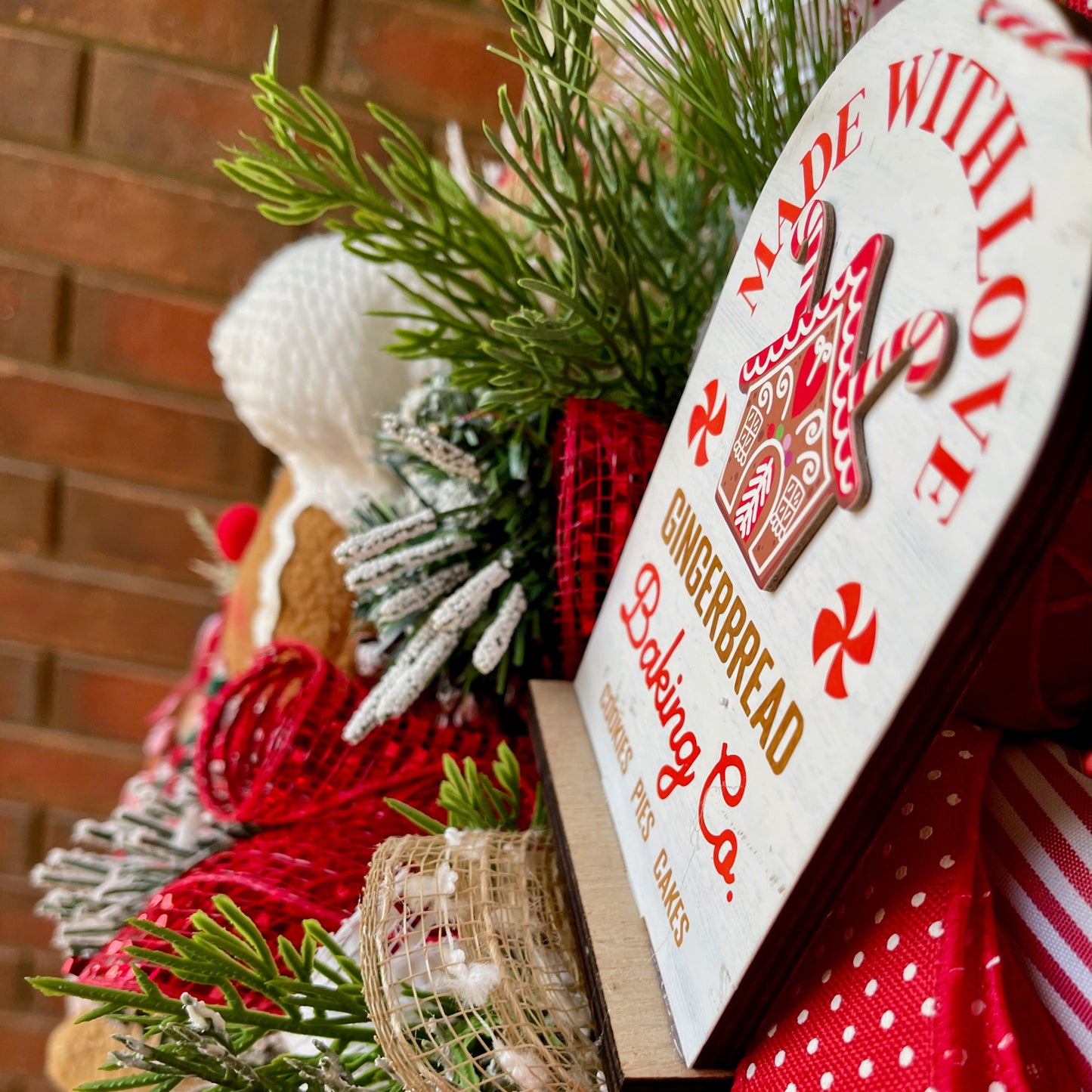 Heart-shaped gingerbread box with 'Made with Love' text, surrounded by Christmas decorations.