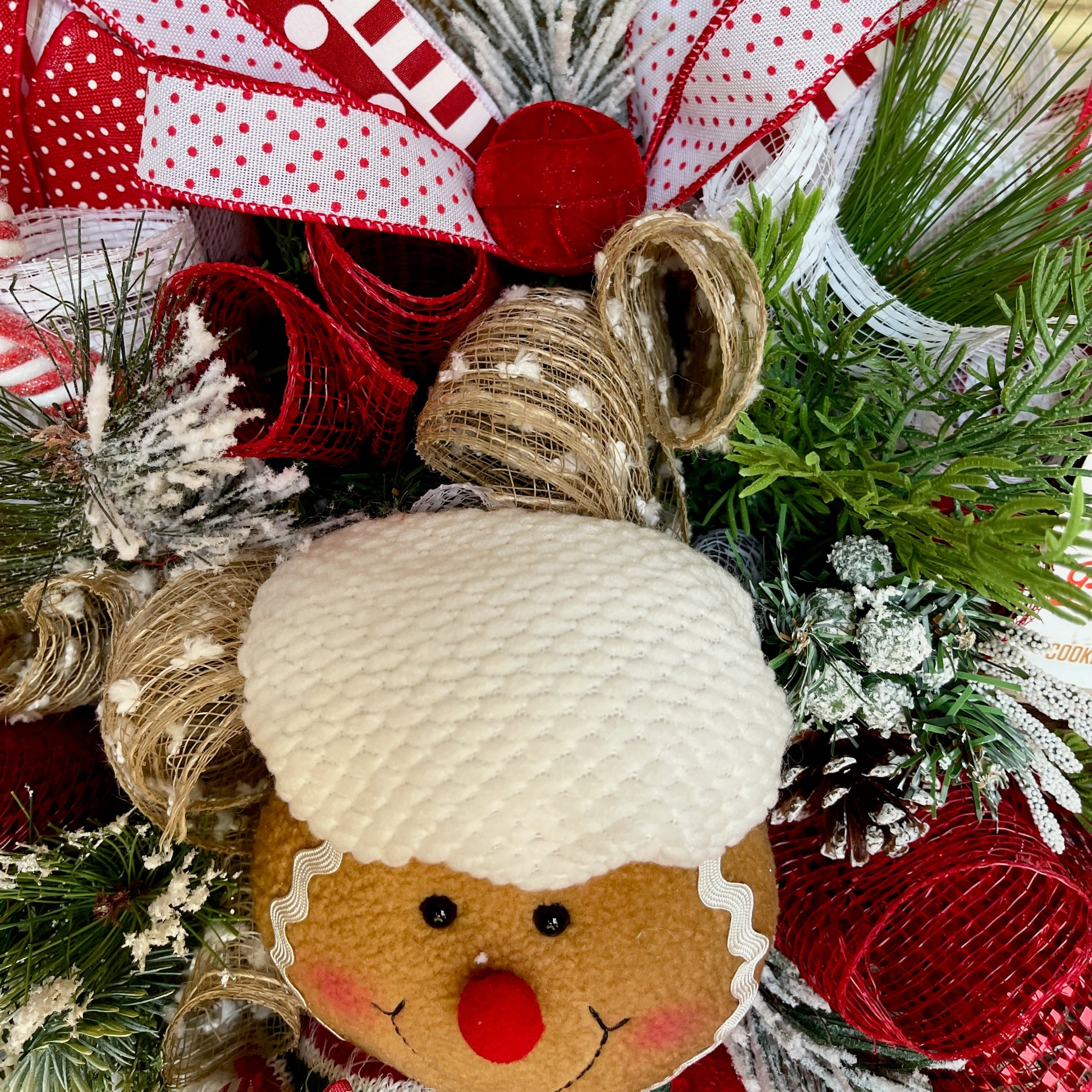 Decorative wreath with gingerbread man ornament and festive elements