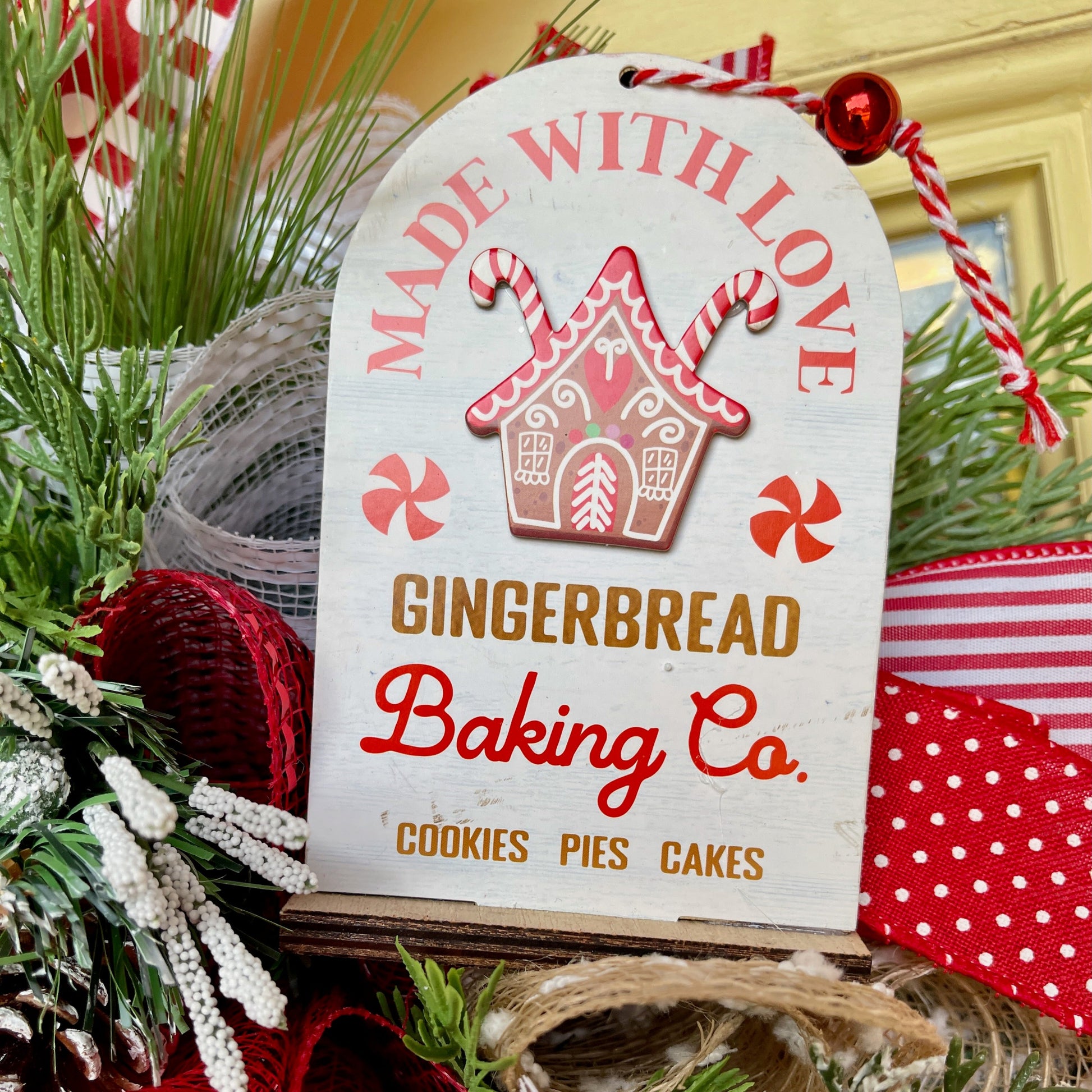 Decorative sign for Gingerbread Baking Co. with Christmas-themed elements.