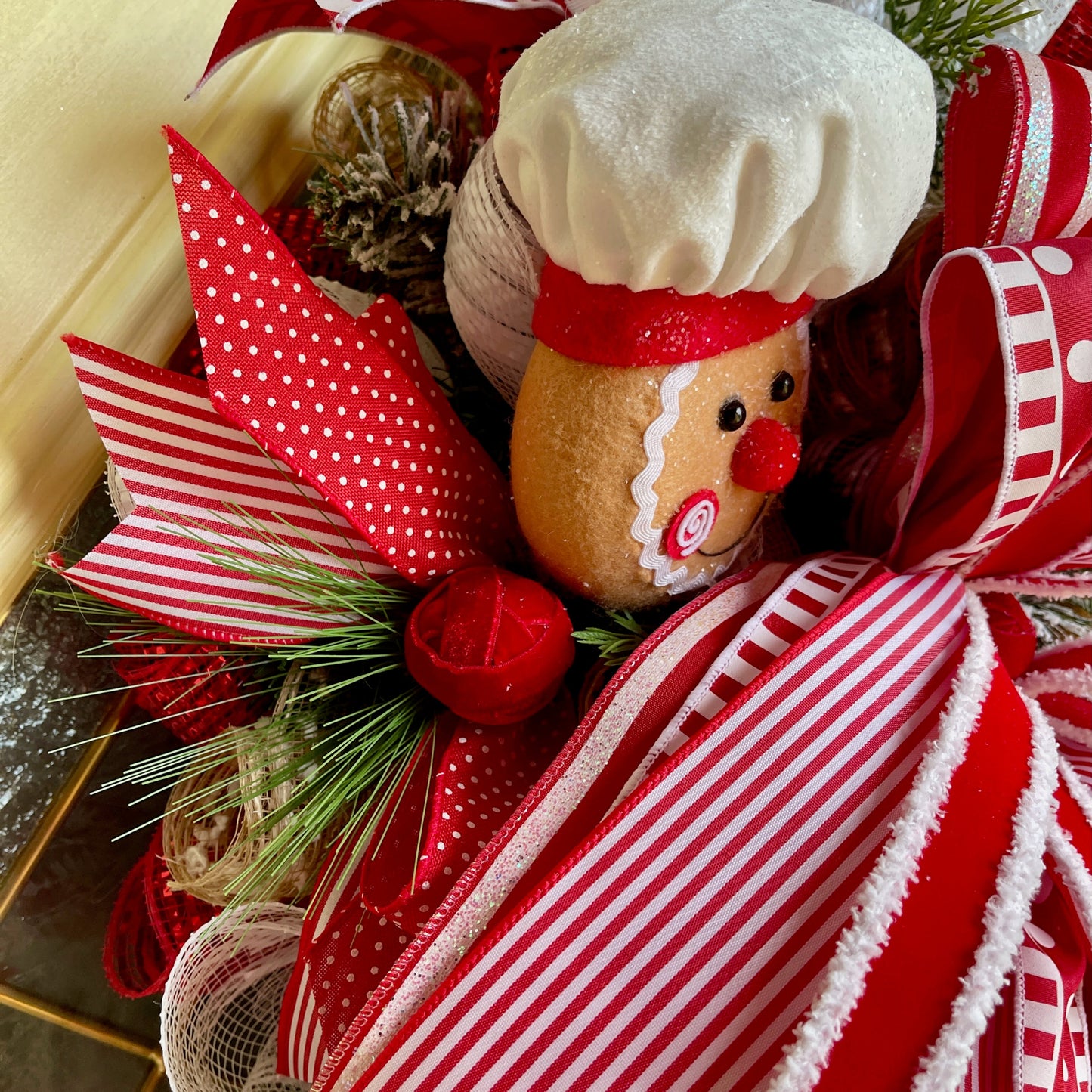 Decorative wreath with gingerbread man and red ribbons