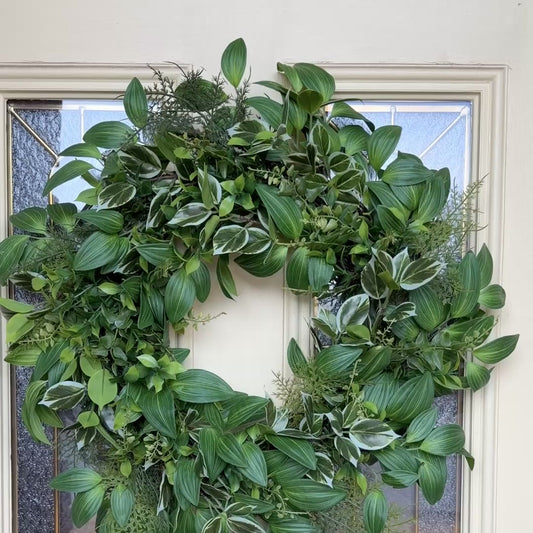Handcrafted lush greenery front door wreath with white roses. Elegant farmhouse decor perfect for spring, summer, and year-round display.
